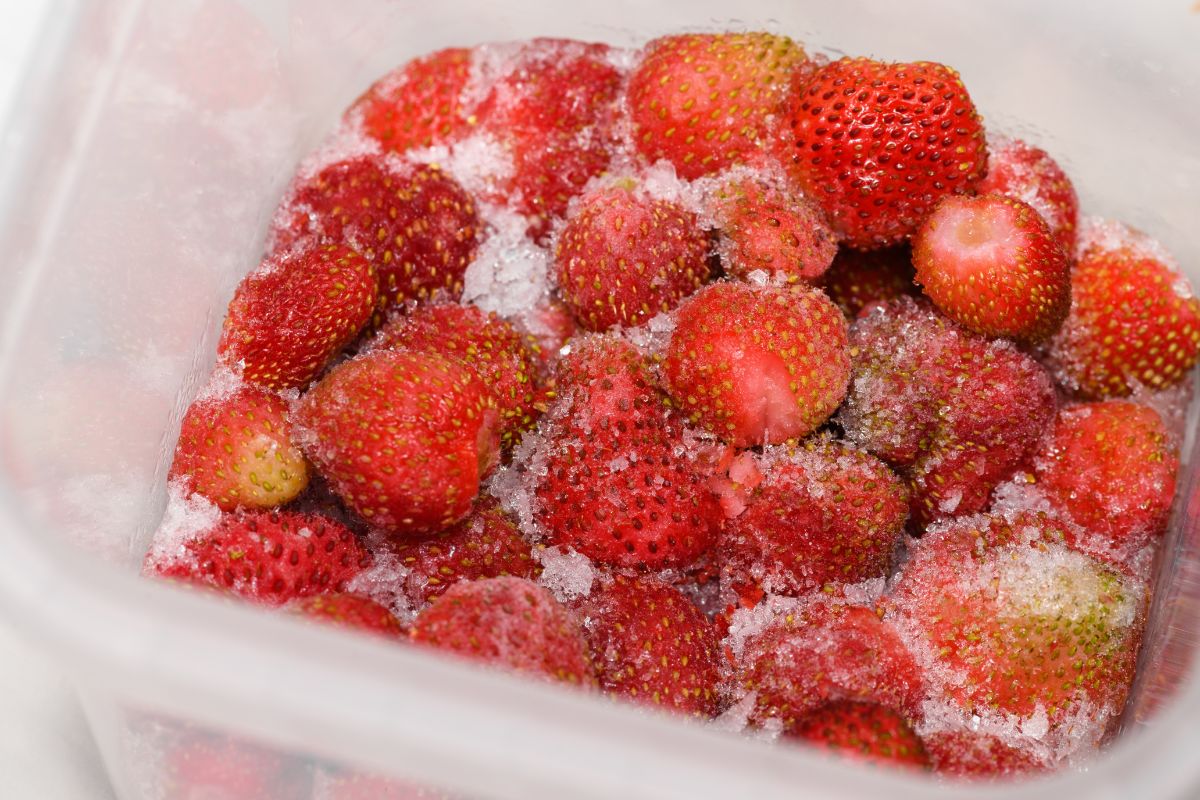 Fozen strawberries in plastic container