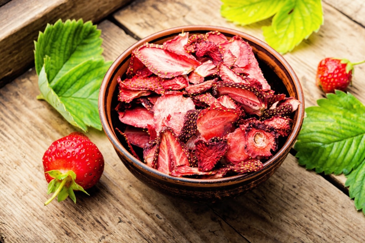Dried strawberries in a wooden bowl.