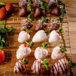 Chocolate dipped strawberries on a cooling rack.