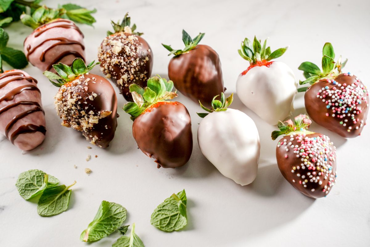 Chocolate dipped strawberries on a white plate..