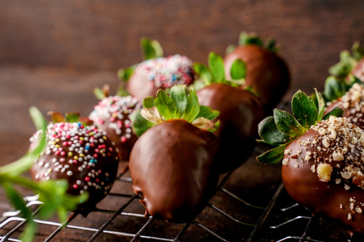 Chocolate dipped strawberries on a cooling rack.