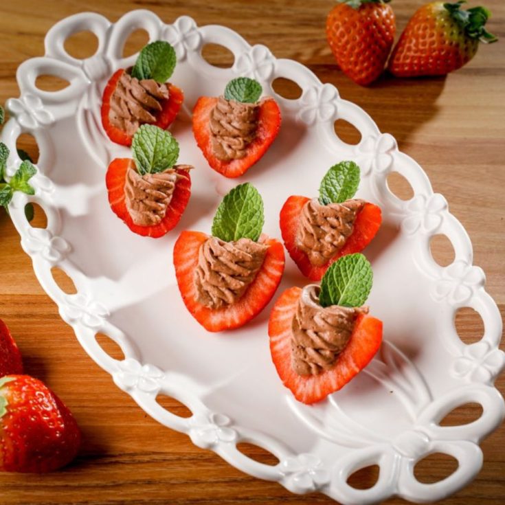 Deviled strawberries on a white tray.