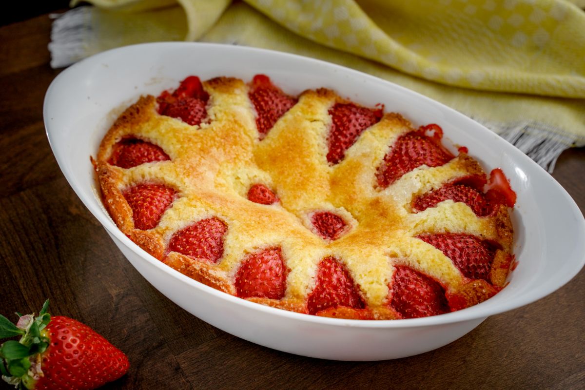 Fresh strawberry cake in a white baking pot.