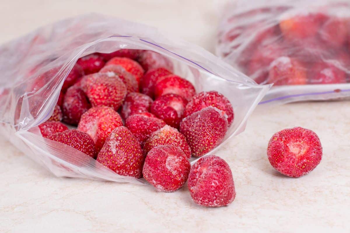Frozen strawberries spilling from a freezer bag