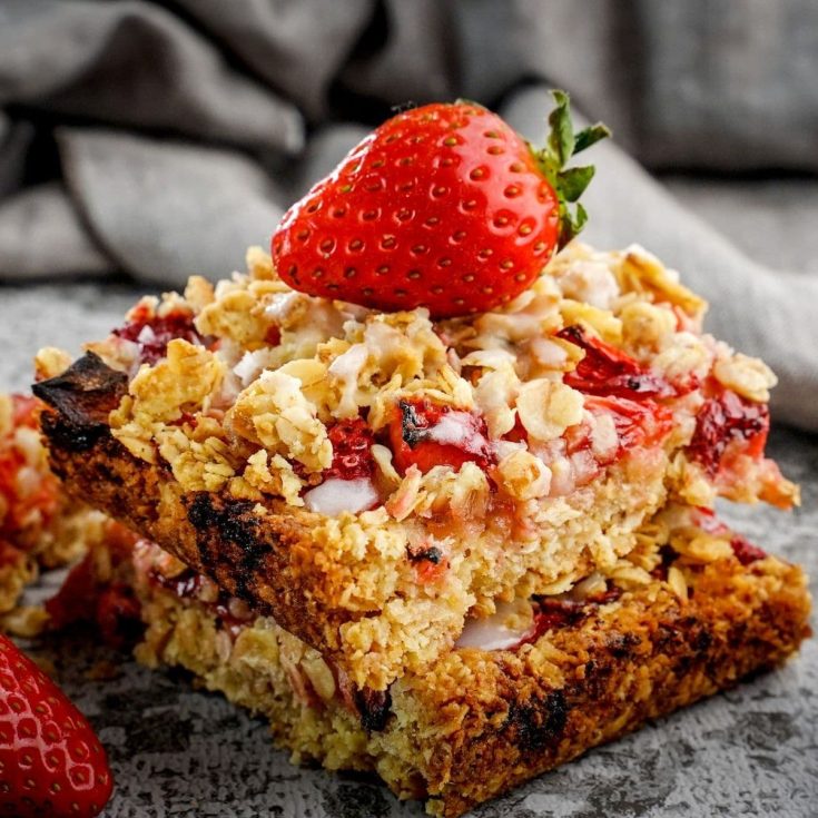 Healthy strawberry outmeal bar with ripe strawberry on the top.