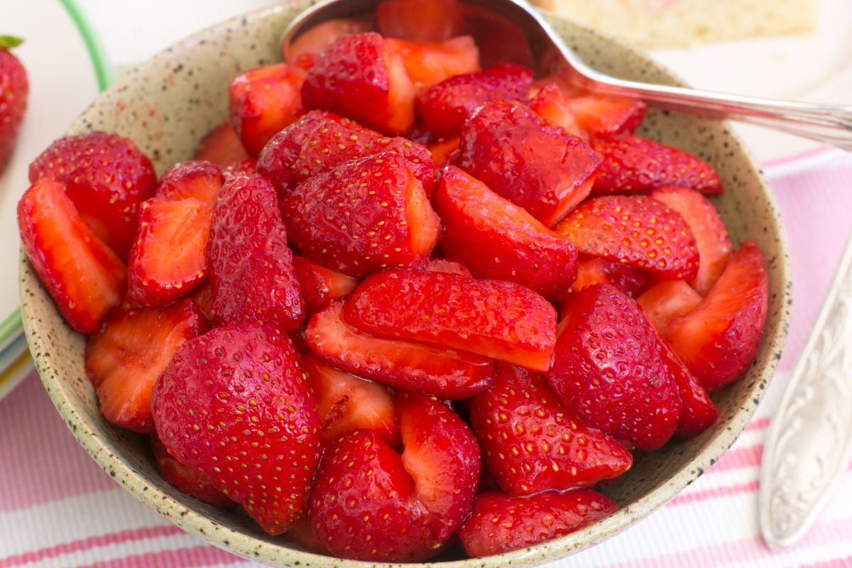 Sliced strawberries macerating in a bowl