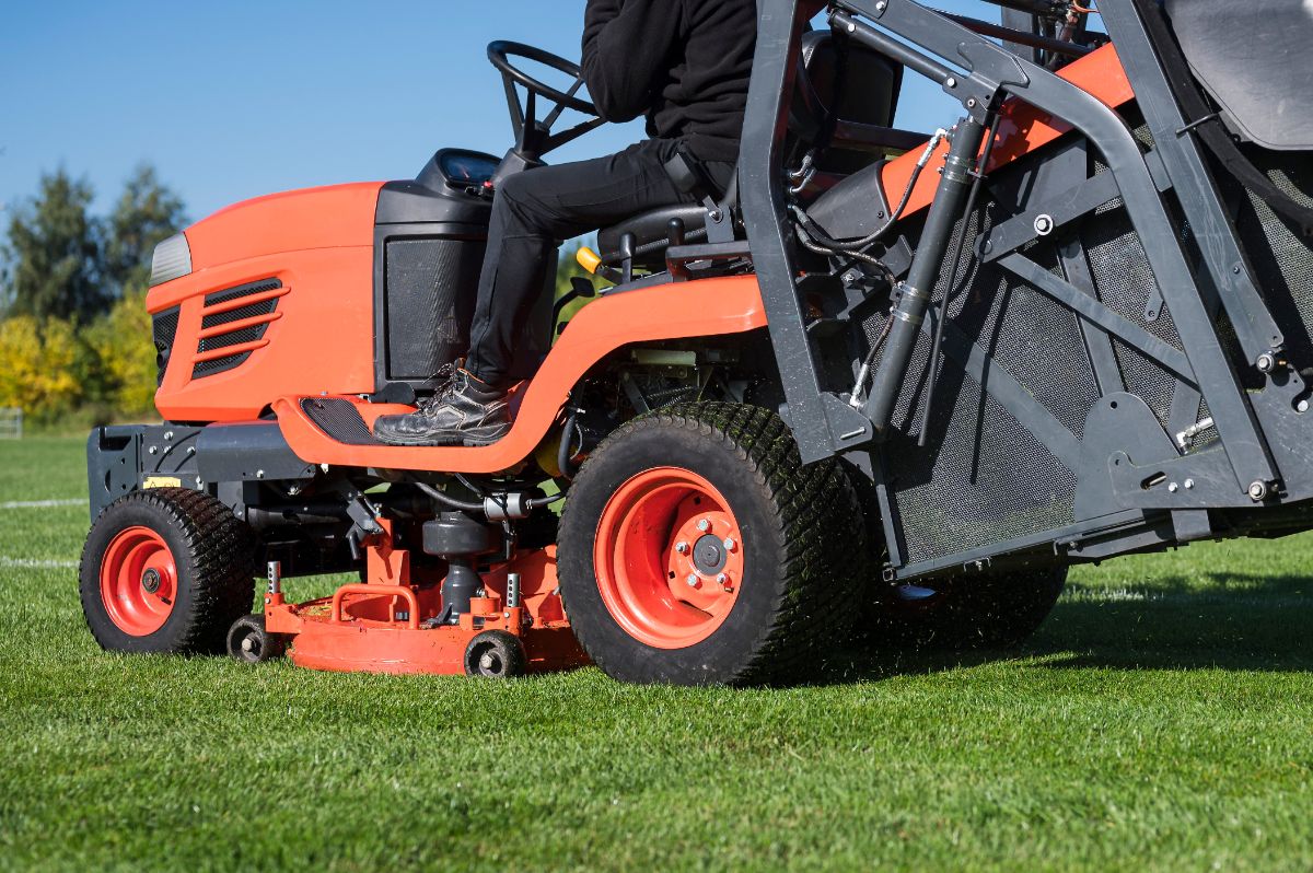 Mowing machine on green grass