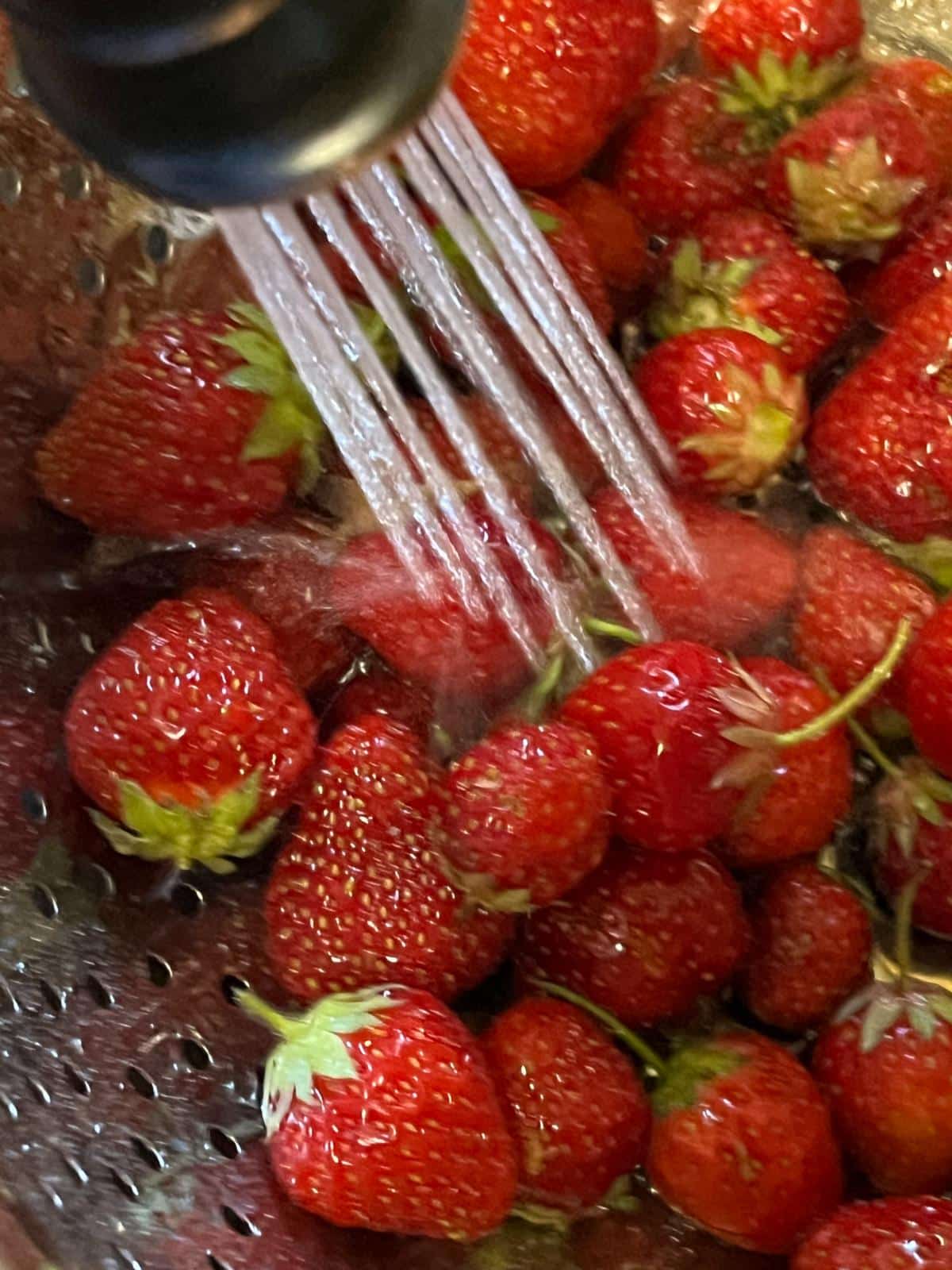 Washing strawberries under water