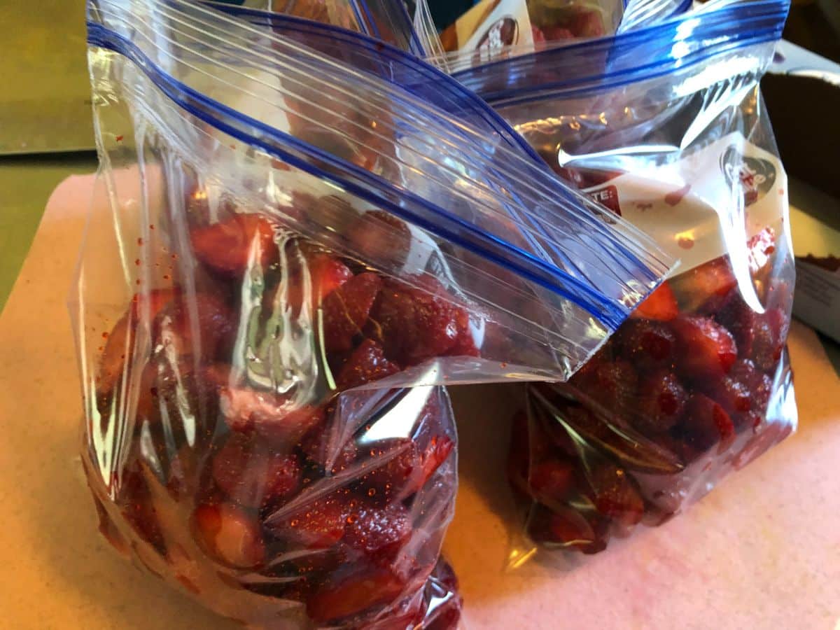 Hulled, sliced strawberries in plastic freezer bags