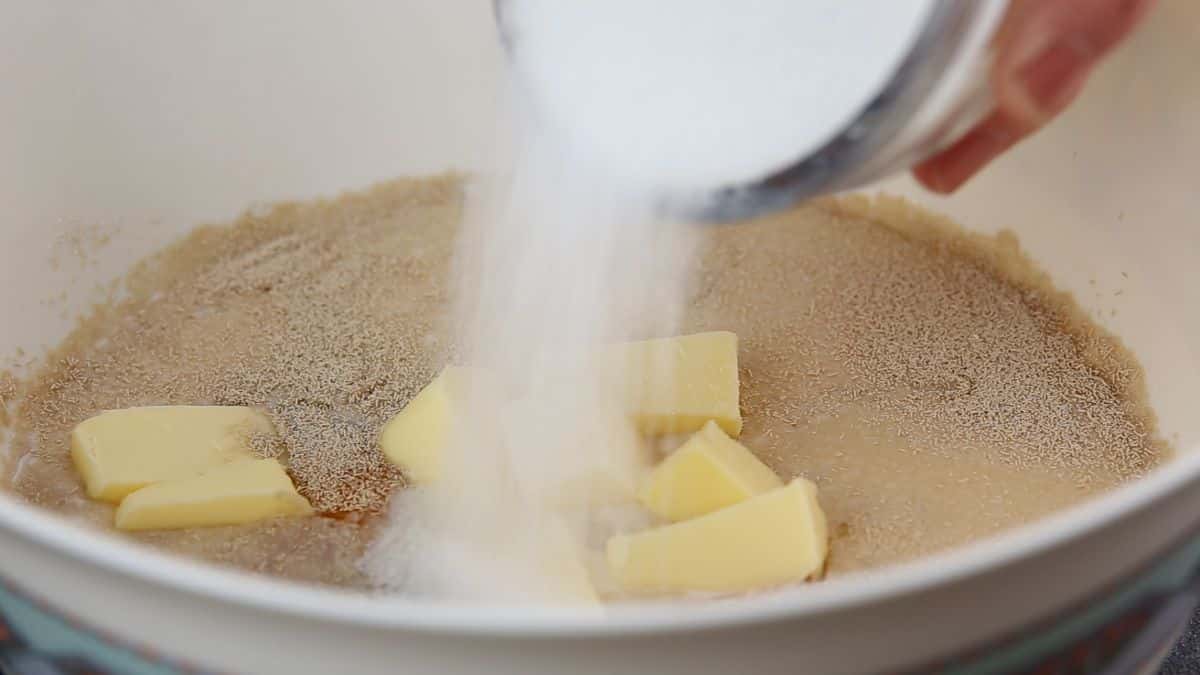 A close-up of pouring sugar in a bowl.
