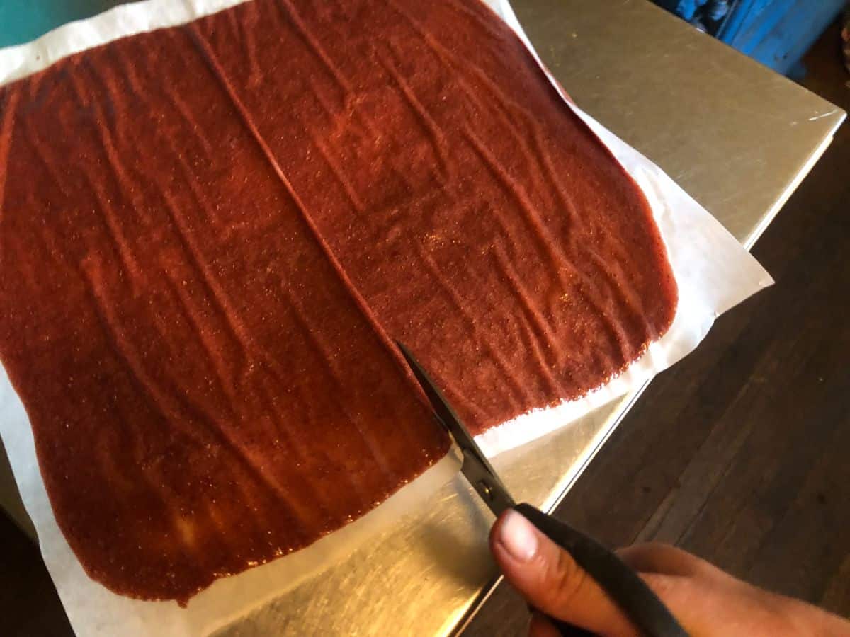 Strawberry fruit rolls being cut for storing