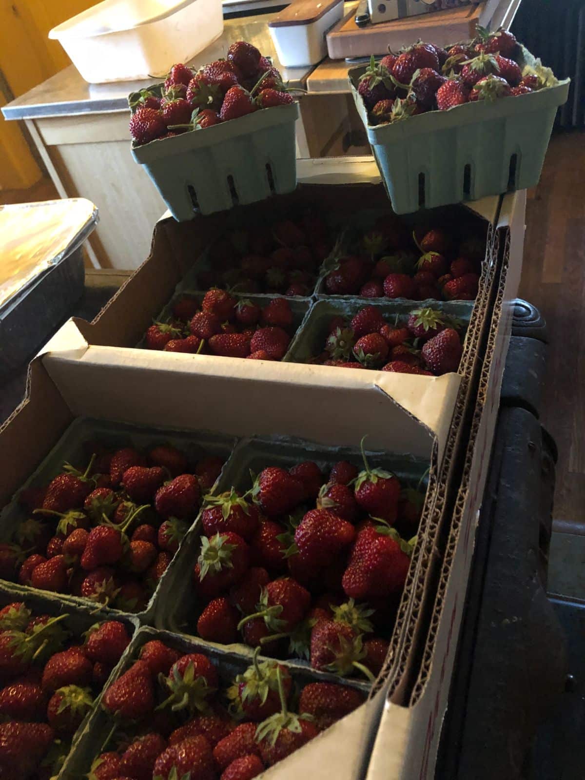Flats and boxes of fresh picked strawberries