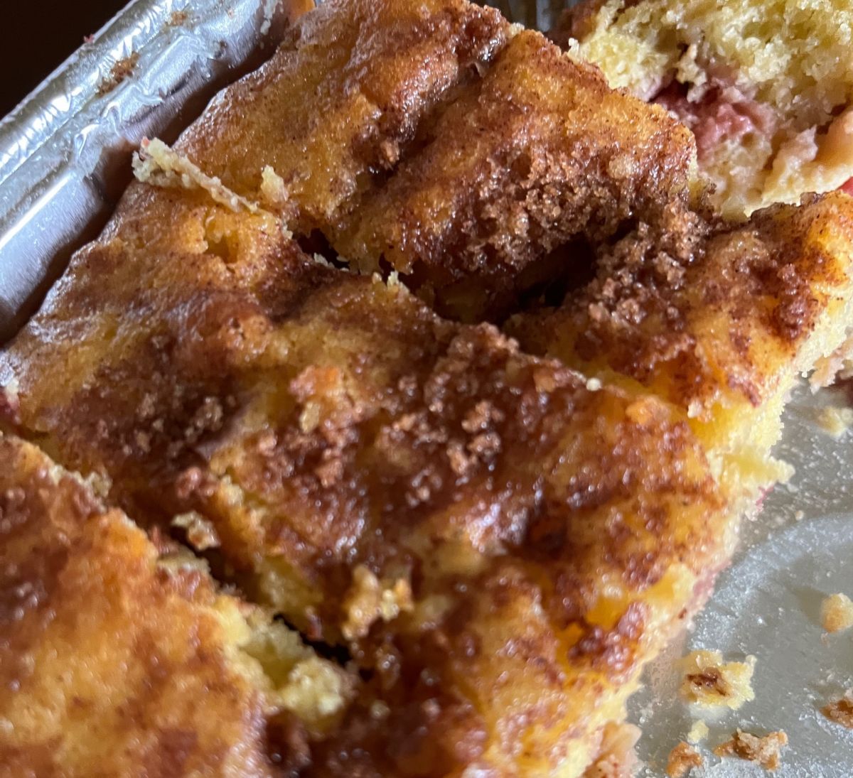 A pan with pieces of strawberry rhubarb coffee cake