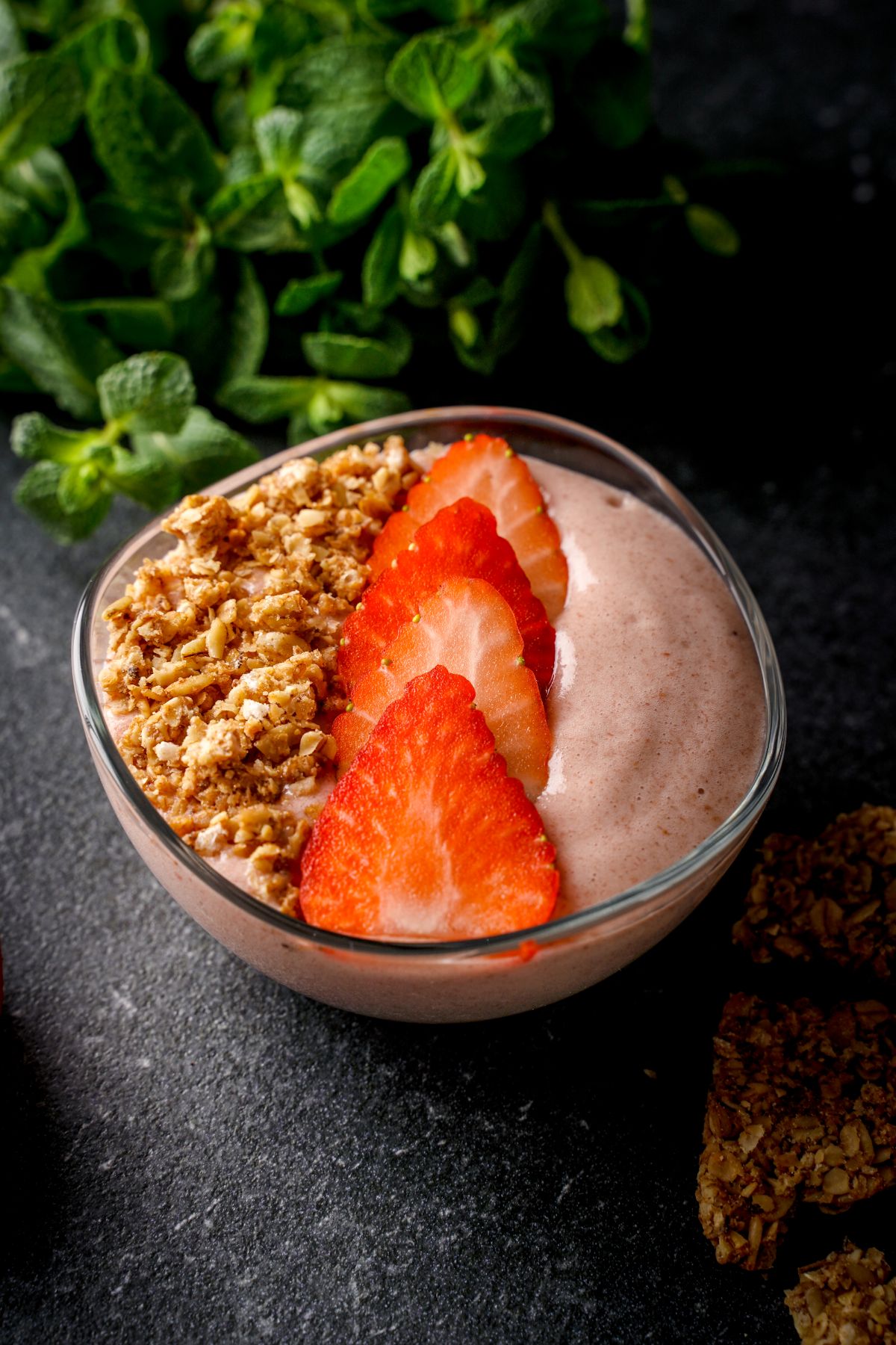 Strawberry vanilla smoothie bowl with sliced strawberries and pecans.